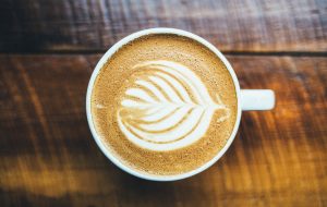 A cup of coffee with a pattern in the froth