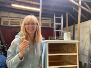 woman in workshop with paintbrush