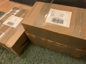 cardboard boxes ready for posting - bookshelf declutter
