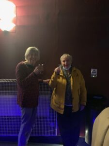 Two old ladies drinking prosecco