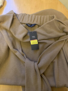 fawn coloured skirt with sale label