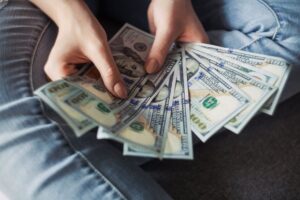 hundreds of dollars in a person's hands