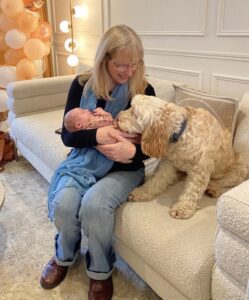 Woman with baby and dog on a sofa