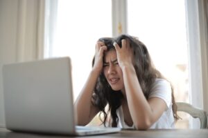 Frustrated woman at a laptop