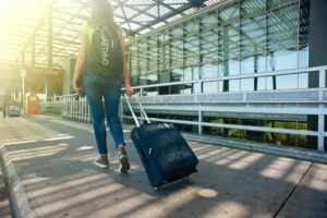 Woman pulling a suitcase