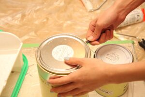 hands opening some paint pots