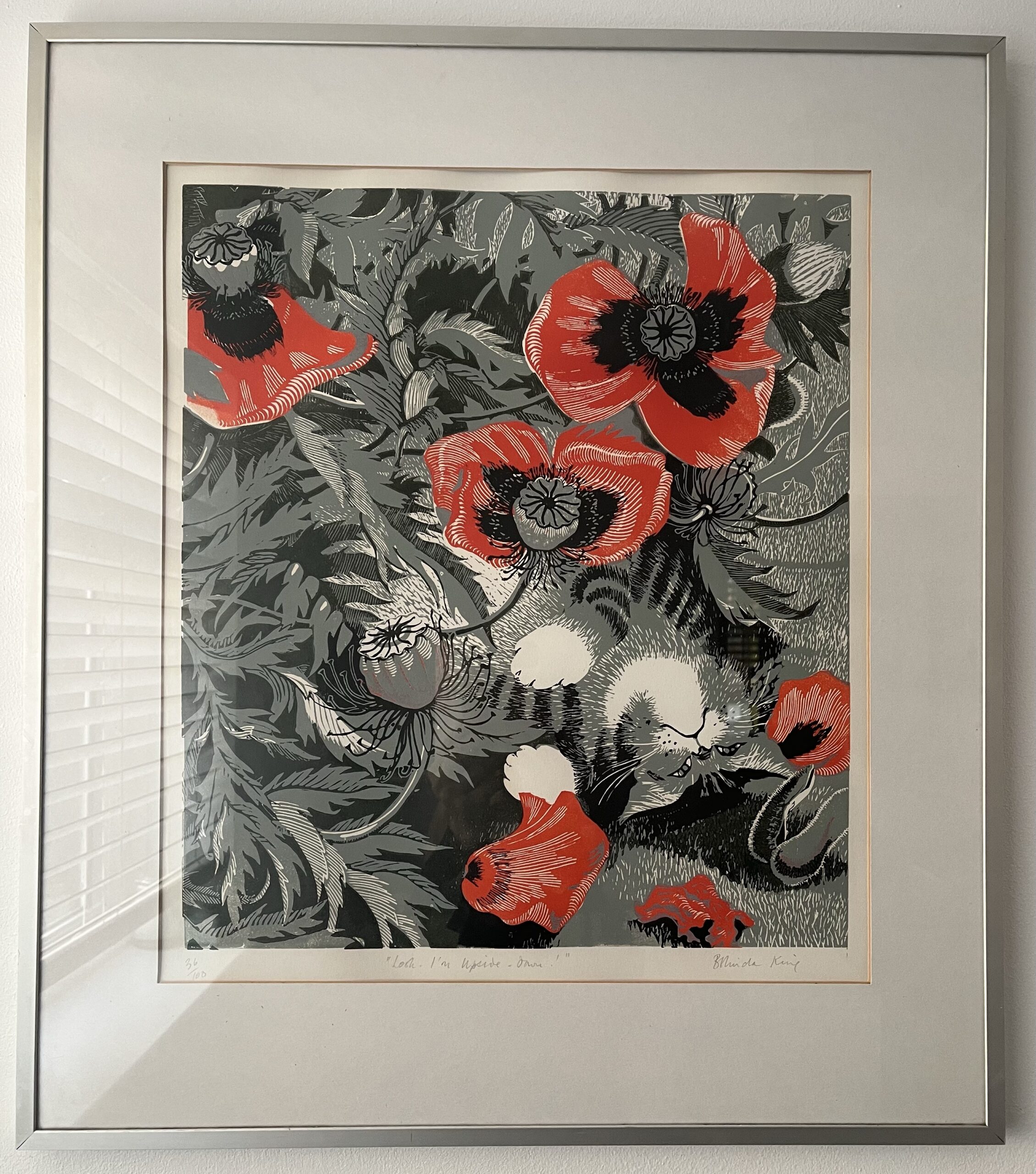 Painting of a cat in some poppies