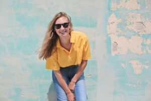 woman in a yellow shirt with sunglasses