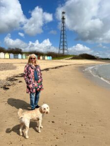 Me in a floral coat on a beach