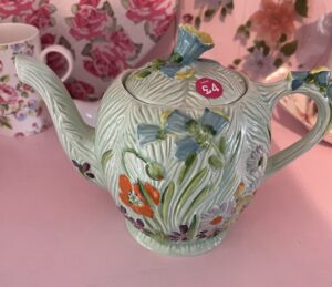 A green floral teapot