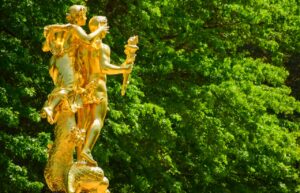 Two gold coloured outdoor statues
