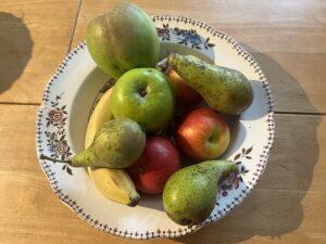 A bowl of apples and pears with a banana