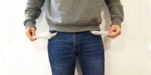 A man's body with pockets pulled out to show they are empty