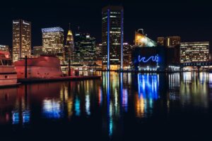 city at night lit up and reflected in the water