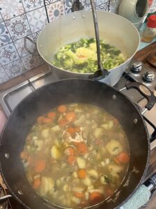 Two large pans full of chopped veggie soup