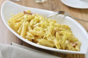 A bowl of macaroni with cheese sauce