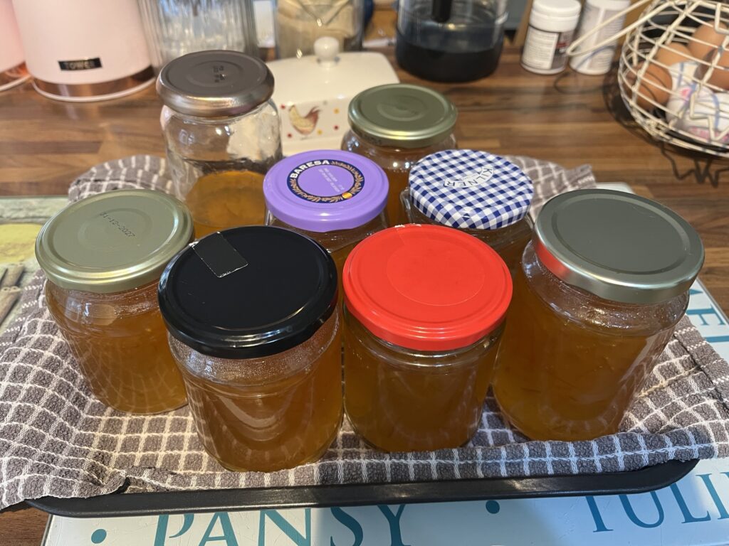 Several jars of marmalade on a tray