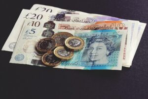 British bank notes and coins laid out