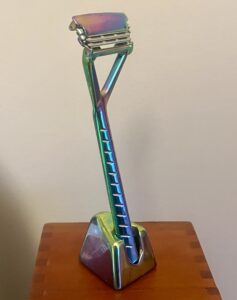 A metal razor on a stand