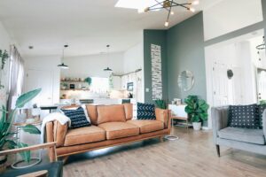 A modern living room with large leather sofa and a green wall