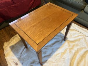 A small dark wooden side table