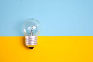 A light bulb against a blue and yellow background