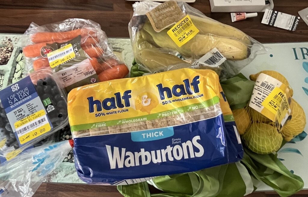 Five grocery items with reduced price yellow stickers on them