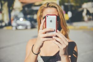 A girl with her face obscured by her phone