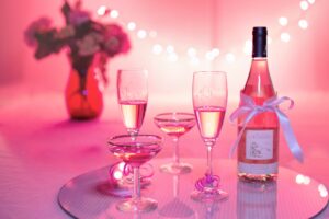 A bottle of sparkling wine and glasses on a table